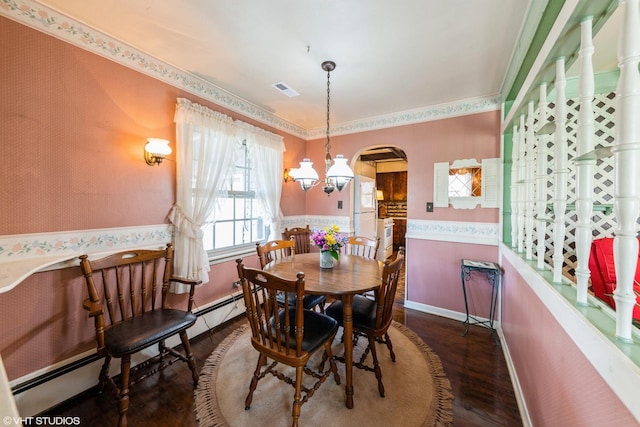 635 N Greenleaf St, Gurnee, IL 60031 - dining room with arched walkways, wallpapered walls, a notable chandelier, and wood finished floors