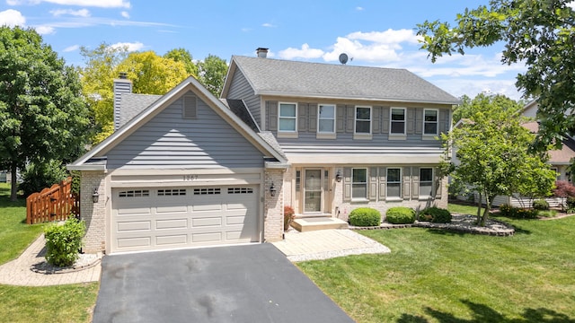 1267 Churchill Rd, Bartlett, IL 60103 - view of front of home with brick siding, an attached garage, asphalt driveway, and a front lawn