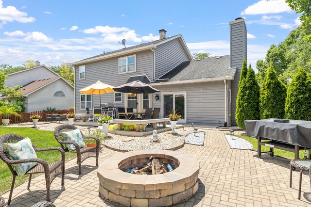 1267 Churchill Rd, Bartlett, IL 60103 - rear view of house with a fire pit, a patio, a chimney, and outdoor dining space