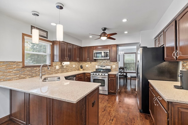 1267 Churchill Rd, Bartlett, IL 60103 - kitchen featuring appliances with stainless steel finishes, a peninsula, ceiling fan, dark wood finished floors, and backsplash