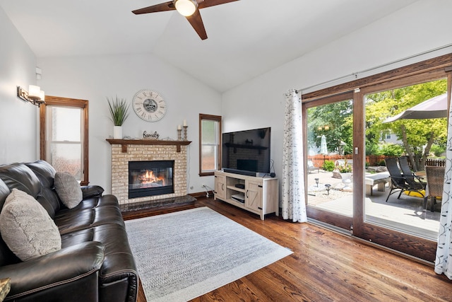 1267 Churchill Rd, Bartlett, IL 60103 - living room featuring vaulted ceiling, a ceiling fan, a fireplace, and wood finished floors