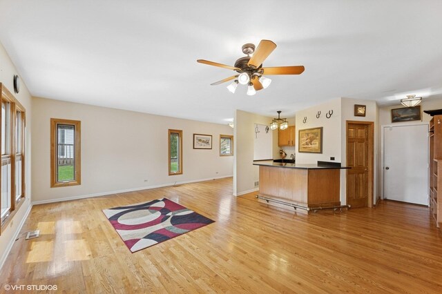 unfurnished dining area with carpet flooring, baseboards, an inviting chandelier, and visible vents
