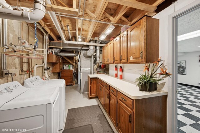finished below grade area with tile patterned floors, baseboards, and a paneled ceiling