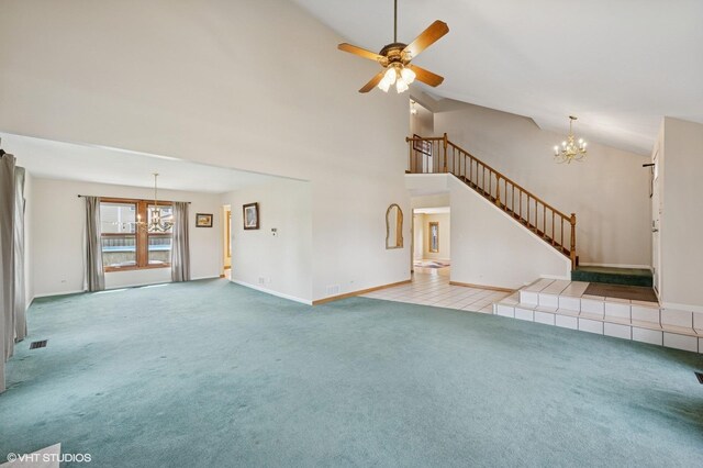 unfurnished living room featuring carpet flooring, a fireplace, high vaulted ceiling, ceiling fan with notable chandelier, and stairway