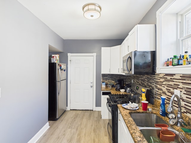 162 N La Crosse Ave, Chicago, IL 60644 - kitchen featuring light wood-type flooring, a sink, decorative backsplash, and appliances with stainless steel finishes