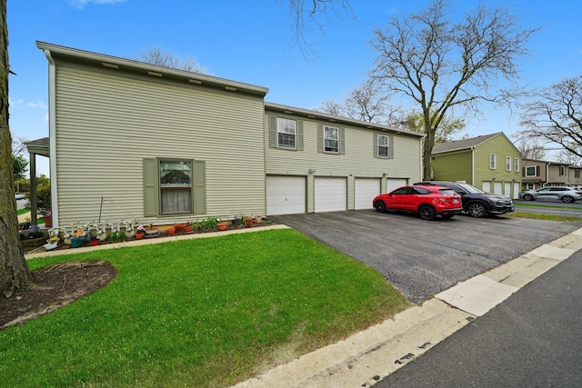1668 Valley Forge Ct Unit D, Wheaton, IL 60189 - view of front of house with an attached garage, driveway, and a front yard