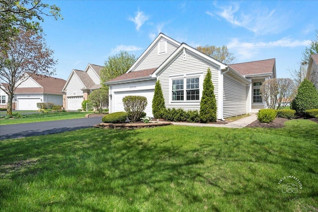 21600 W Larch Dr, Plainfield, IL 60544 - view of front facade featuring aphalt driveway, an attached garage, and a front yard