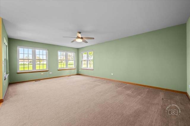 21600 W Larch Dr, Plainfield, IL 60544 - carpeted spare room with visible vents, baseboards, and a ceiling fan