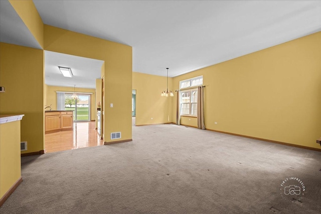 21600 W Larch Dr, Plainfield, IL 60544 - empty room featuring baseboards, light carpet, an inviting chandelier, and visible vents