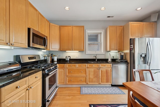 1935 Sherman Ave Unit 2N, Evanston, IL 60201 - kitchen with stainless steel appliances, a sink, light wood finished floors, dark stone countertops, and recessed lighting