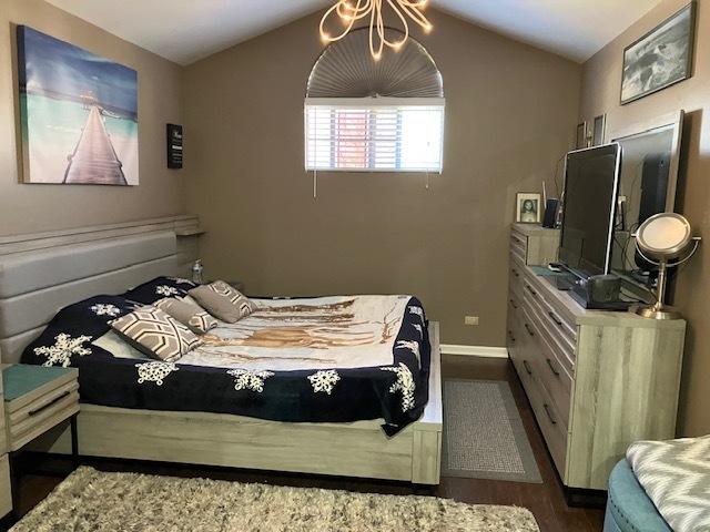 1032 Rockport Dr Unit 1032, Carol Stream, IL 60188 - bedroom with lofted ceiling, baseboards, and dark wood finished floors