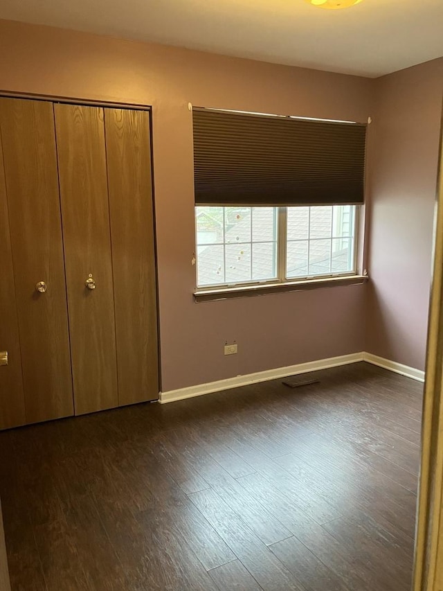 1032 Rockport Dr Unit 1032, Carol Stream, IL 60188 - unfurnished bedroom with baseboards, multiple windows, and dark wood-style floors