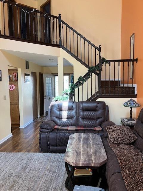 1032 Rockport Dr Unit 1032, Carol Stream, IL 60188 - living room featuring wood finished floors, a high ceiling, visible vents, stairway, and baseboards