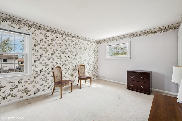 living area featuring carpet floors, wallpapered walls, baseboards, and a wealth of natural light