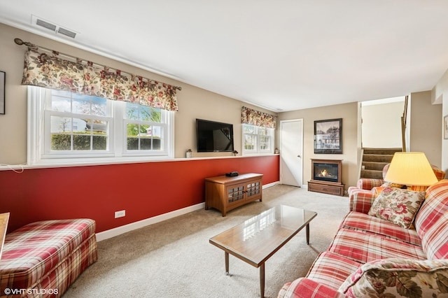 living room with visible vents, a healthy amount of sunlight, and carpet