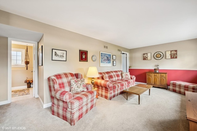carpeted living room featuring baseboards and visible vents