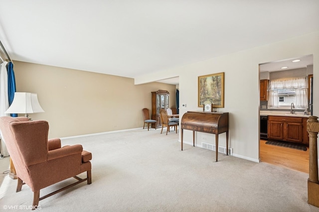sitting room featuring baseboards, a wealth of natural light, light carpet, and visible vents