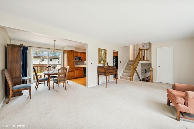 living room with baseboards, a notable chandelier, stairs, and light colored carpet