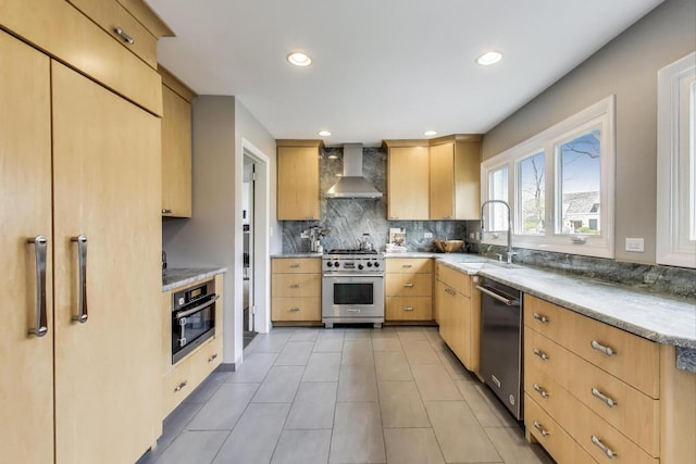 kitchen with a sink, light brown cabinets, wall chimney exhaust hood, stainless steel appliances, and backsplash