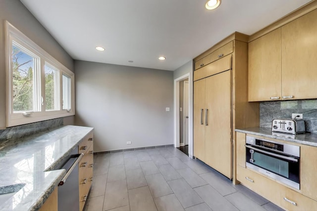 kitchen featuring decorative backsplash, a toaster, light stone counters, stainless steel appliances, and recessed lighting
