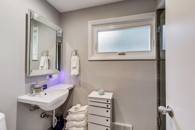 bathroom with toilet and visible vents
