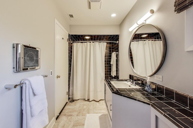 full bath featuring visible vents, vanity, marble finish floor, curtained shower, and an AC wall unit