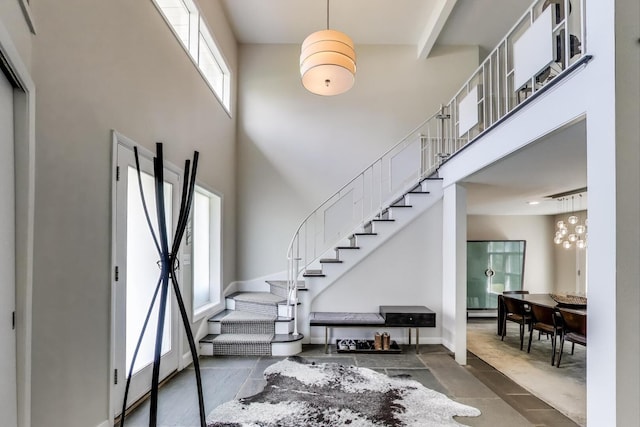 entryway featuring a high ceiling and stairway