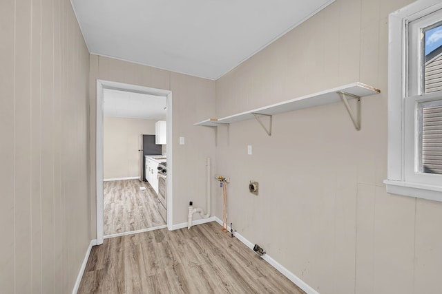 washroom with electric dryer hookup, baseboards, laundry area, and light wood-style flooring