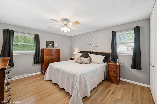 310 N Lytle Dr, Palatine, IL 60074 - bedroom featuring multiple windows, light wood-style floors, baseboards, and ceiling fan