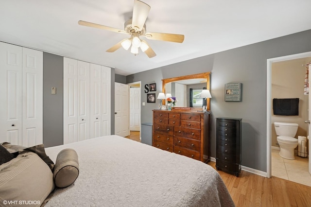 310 N Lytle Dr, Palatine, IL 60074 - bedroom featuring light wood-type flooring, ensuite bathroom, multiple closets, baseboards, and a ceiling fan