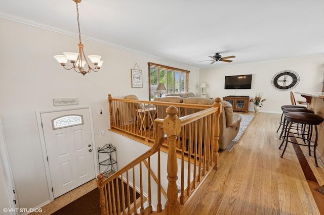 310 N Lytle Dr, Palatine, IL 60074 - living area with light wood finished floors, a ceiling fan, a chandelier, ornamental molding, and baseboards