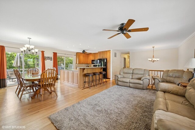 310 N Lytle Dr, Palatine, IL 60074 - living room with a chandelier, ornamental molding, light wood-style flooring, and a ceiling fan