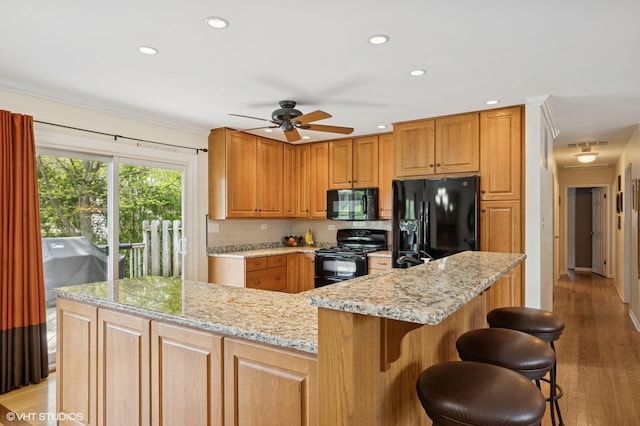 310 N Lytle Dr, Palatine, IL 60074 - kitchen with black appliances, light stone counters, a ceiling fan, recessed lighting, and light wood-style flooring