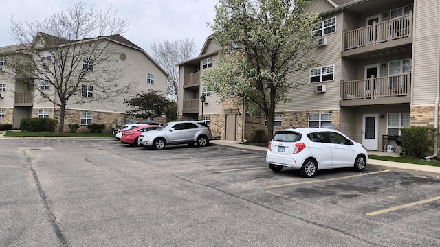 1524 W Sand Bar Ct Unit 2A, Round Lake, IL 60073 - view of building exterior with uncovered parking and a wall mounted air conditioner