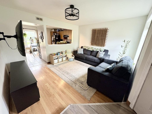 living room featuring visible vents and light wood finished floors