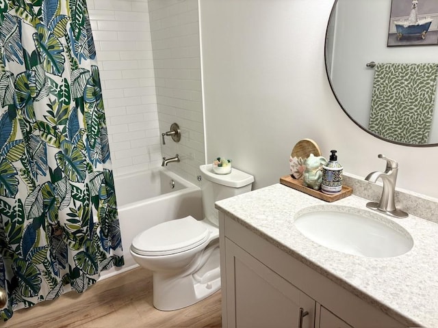 full bathroom featuring toilet, shower / bath combination with curtain, wood finished floors, and vanity