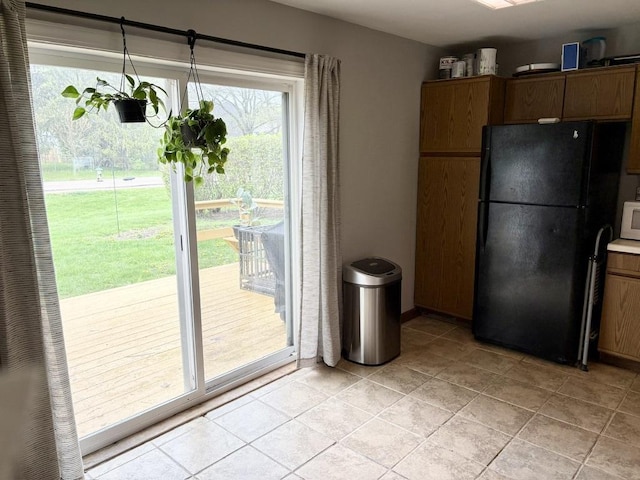 kitchen with freestanding refrigerator and white microwave