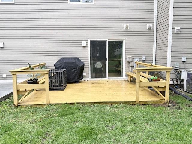 deck with a lawn, central AC, and a grill