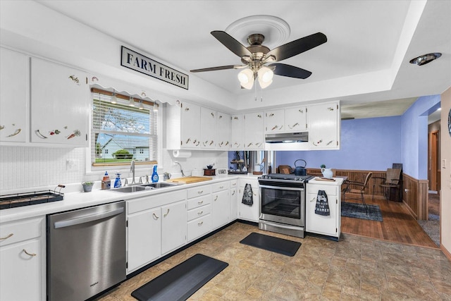 kitchen featuring under cabinet range hood, ceiling fan, a sink, white cabinetry, and appliances with stainless steel finishes