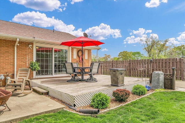 deck with outdoor dining area and fence