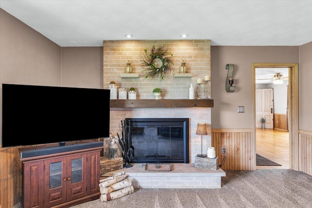 living area with carpet flooring and a fireplace
