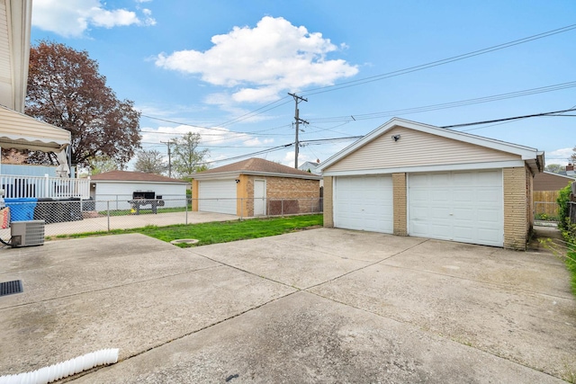 detached garage with fence and central air condition unit