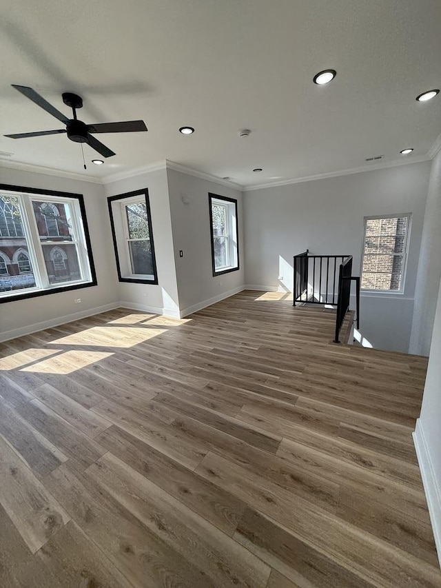 unfurnished living room featuring crown molding and baseboards