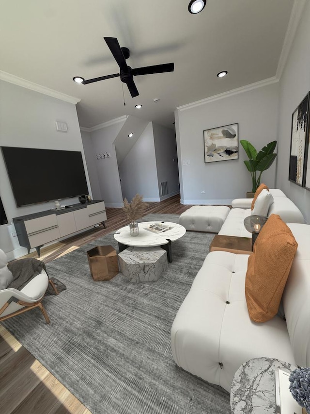 living area featuring baseboards, visible vents, ornamental molding, and wood finished floors