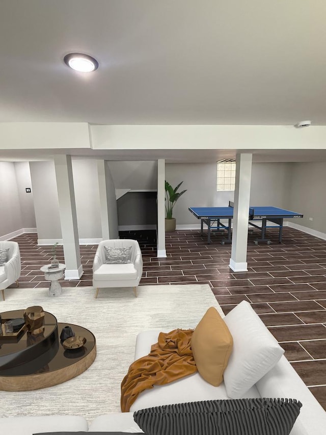 interior space featuring dark wood-style floors, pool table, and baseboards