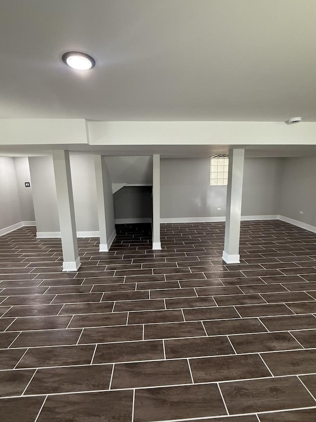 basement featuring dark wood-style floors and baseboards