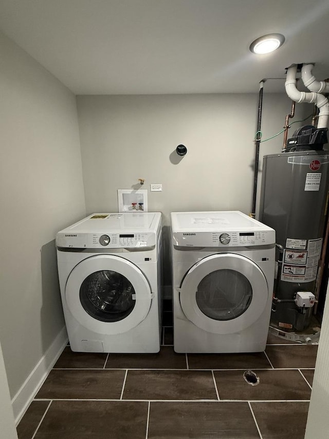 laundry room featuring gas water heater, washing machine and clothes dryer, and laundry area