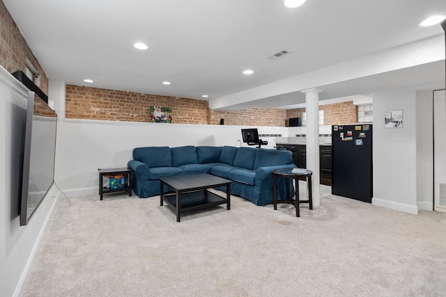 living room featuring visible vents, brick wall, baseboards, recessed lighting, and light colored carpet