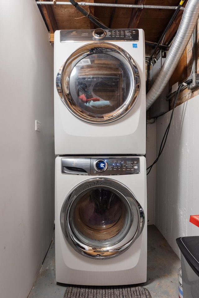 laundry room featuring laundry area and stacked washer / dryer