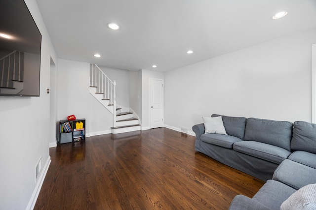 living room with stairway, recessed lighting, wood finished floors, and visible vents